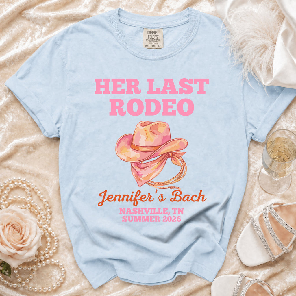 Light blue t-shirt with "Her Last Rodeo" text and cowboy hat graphic.