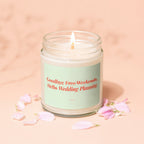 Jar candle with lit wick and pink petals, reading "Goodbye Free Weekends; Hello Wedding Planning."
