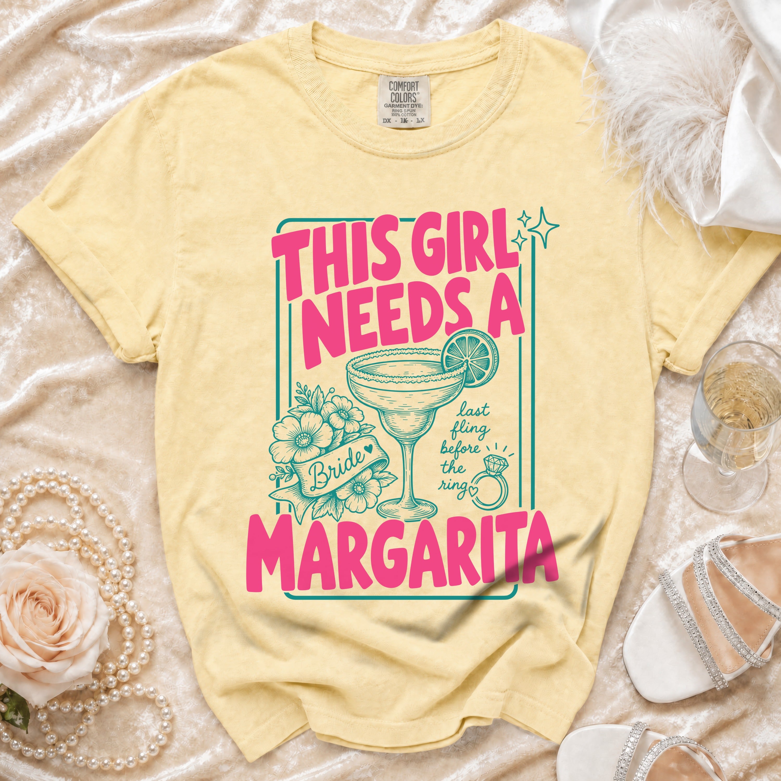 Yellow t-shirt with "This girl needs a margarita" graphic and bridal elements.