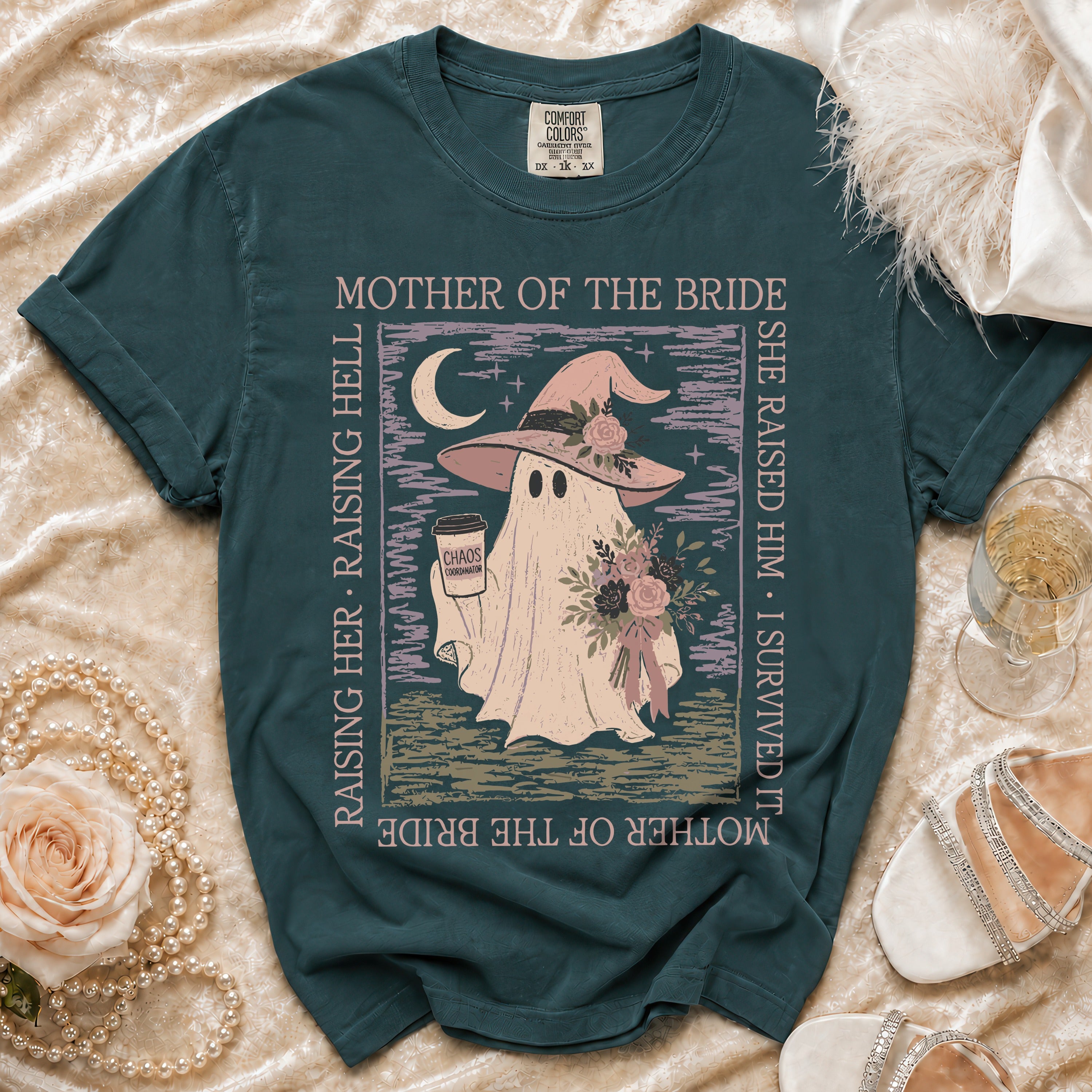 Ghost wearing witch hat and holding coffee, "Mother of the Bride" text, on teal t-shirt.