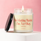 Lit candle in a jar with "She's Getting Married. I'm Not Okay. send wine. VOWED" text.