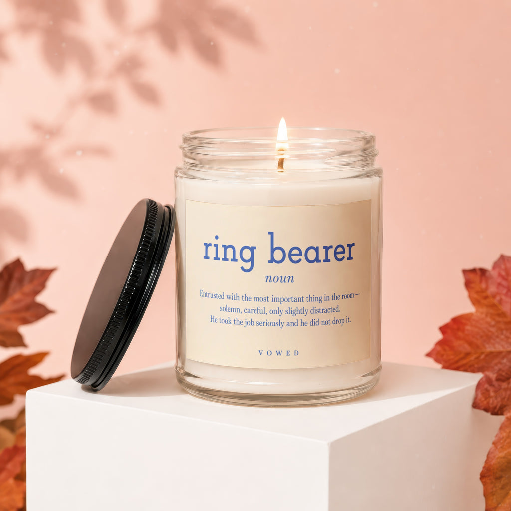 Ring Bearer candle with definition: "Entrusted with the most important thing in the room—solemn, careful, only slightly distracted. He took the job seriously and he did not drop it."