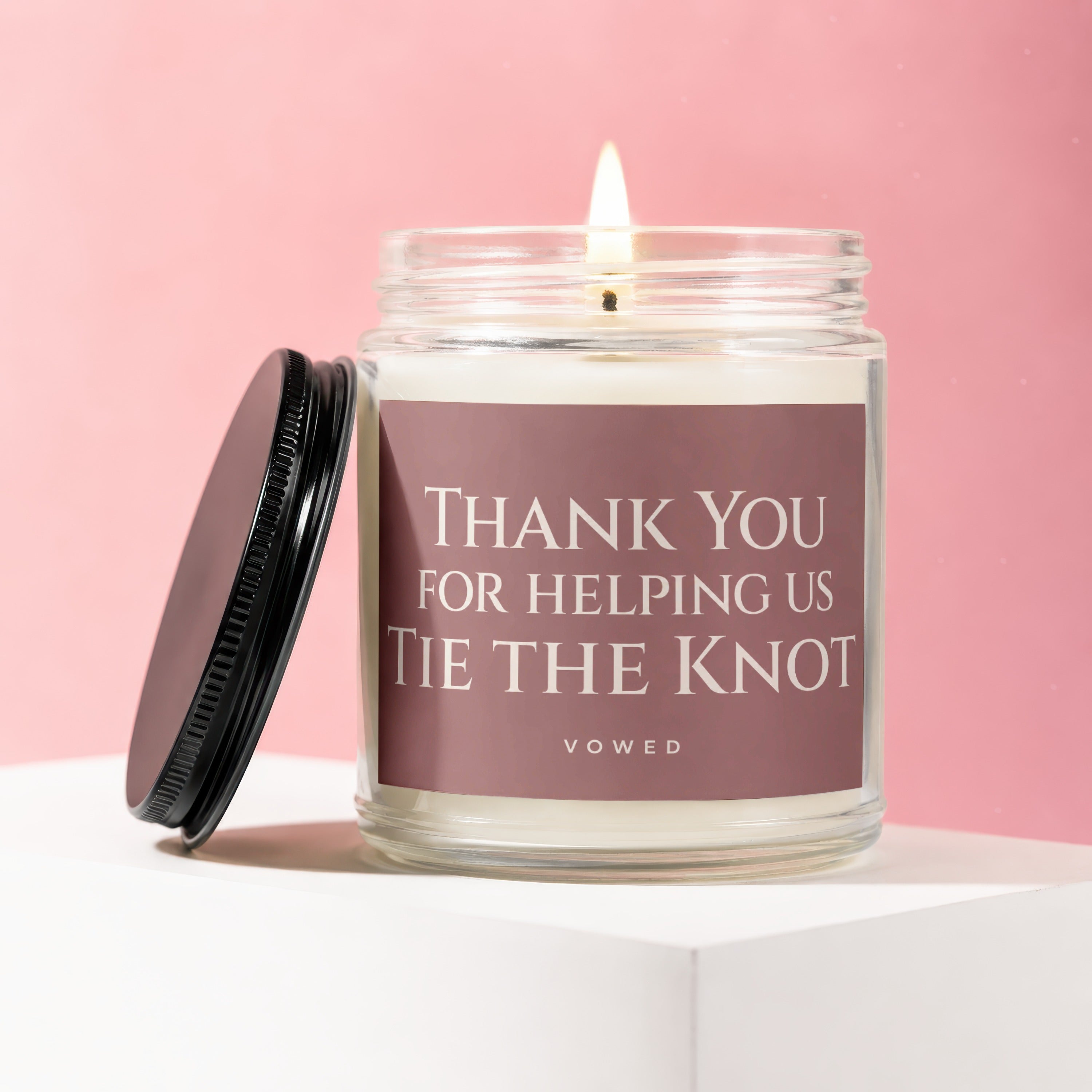 Candle with text "Thank You For Helping Us Tie The Knot" on a pink background.