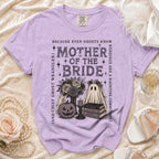 Purple t-shirt with "Mother of the Bride" text and ghost, pumpkin, and book graphics.