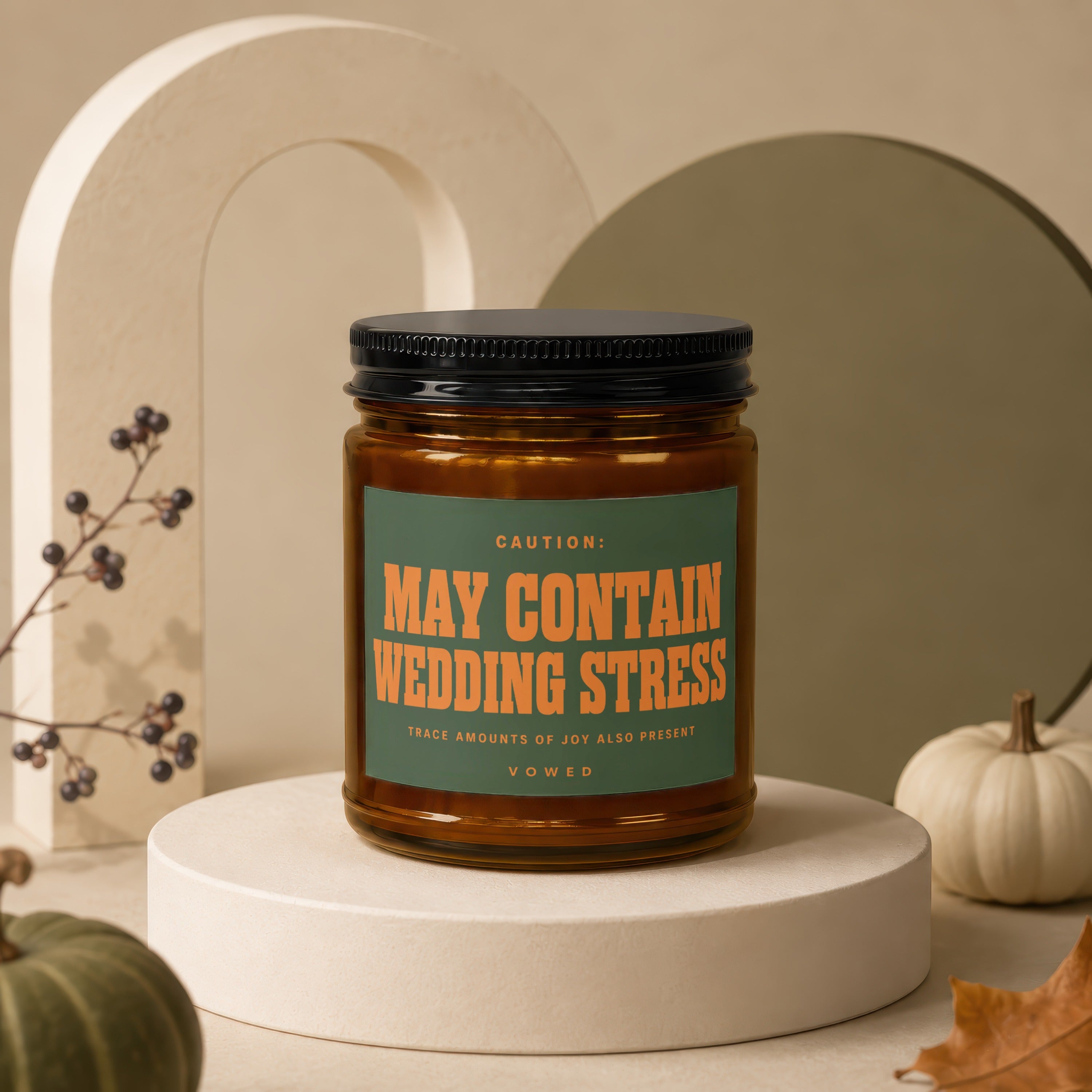 Candle labeled "MAY CONTAIN WEDDING STRESS" and "VOWED" with decorative elements.