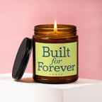 Amber jar candle with lit wick, black lid, and text "Built for Forever VOWED".