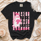 Black t-shirt with ghost bride graphic and text: "half BRIDE half HAUNTED fully booked."