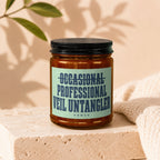 Candle with "OCCASIONAL PROFESSIONAL VEIL UNTANGLER" text on a light blue label.