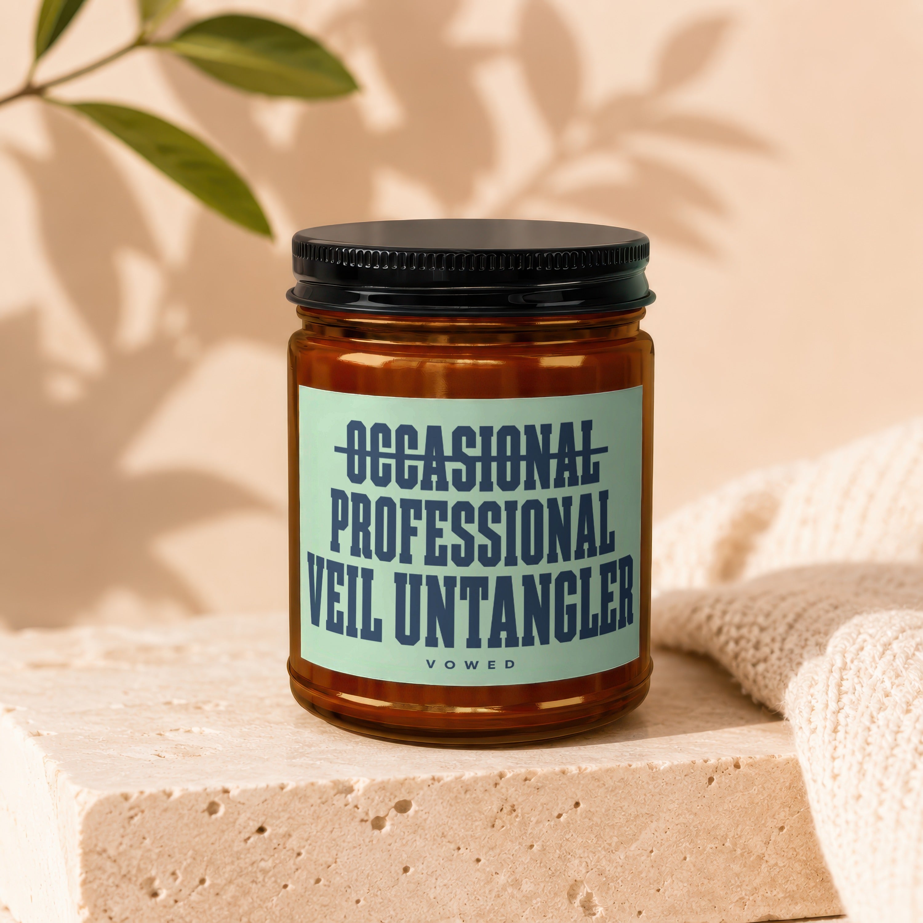 Candle with "OCCASIONAL PROFESSIONAL VEIL UNTANGLER" text on a light blue label.