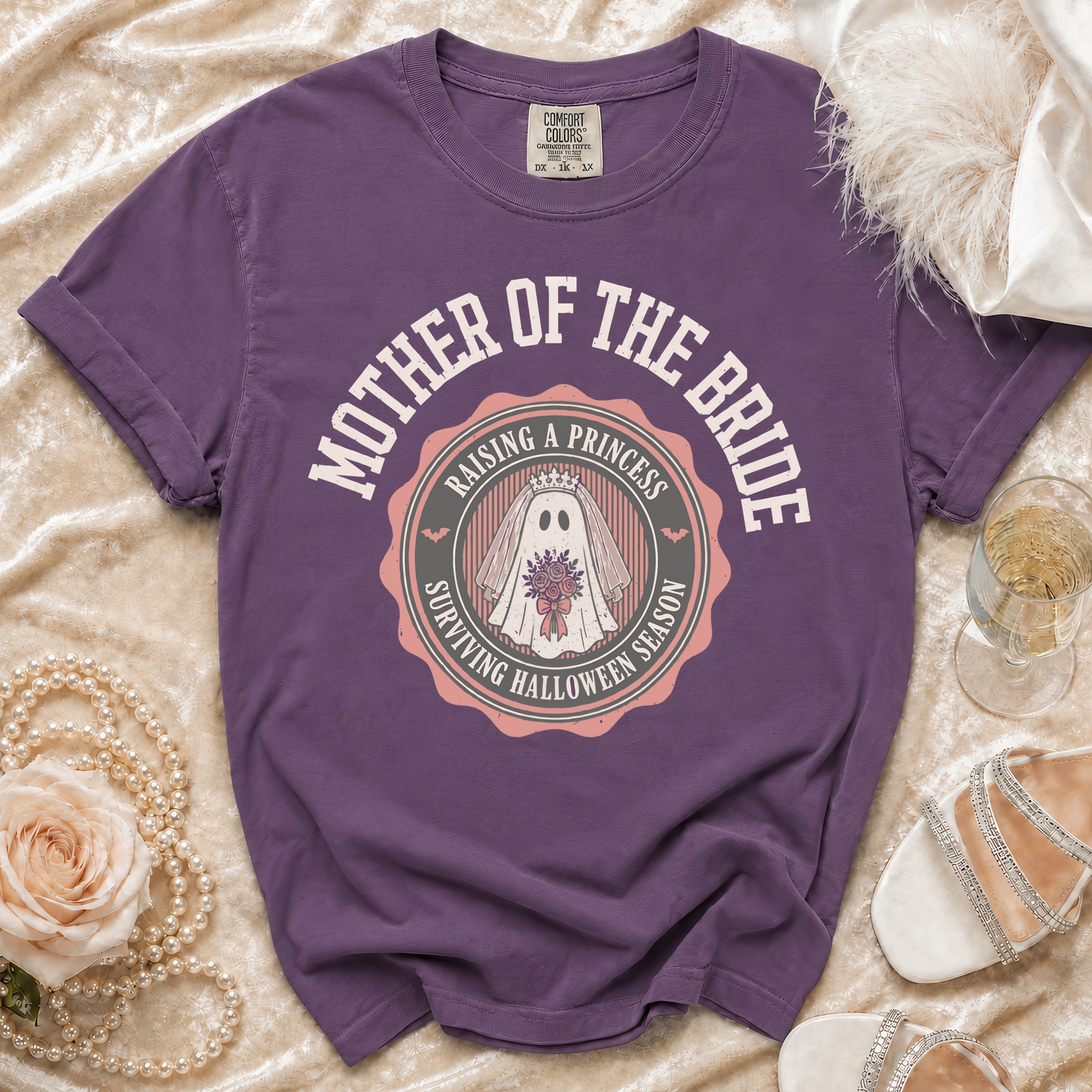 Purple t-shirt with "Mother of the Bride Raising a Princess Surviving Halloween Season" graphic.