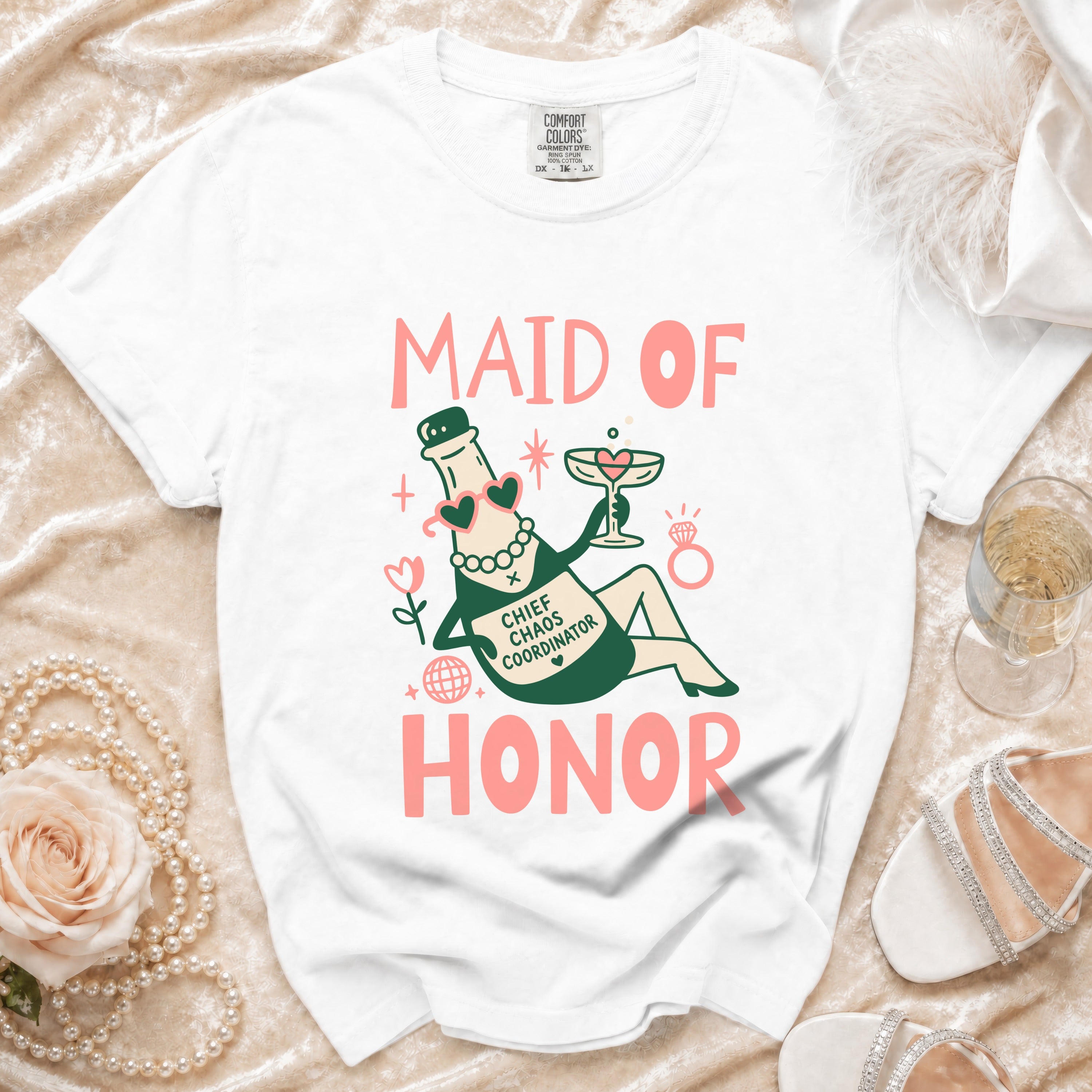 White t-shirt with "Maid of Honor Chief Chaos Coordinator" graphic featuring a champagne bottle.