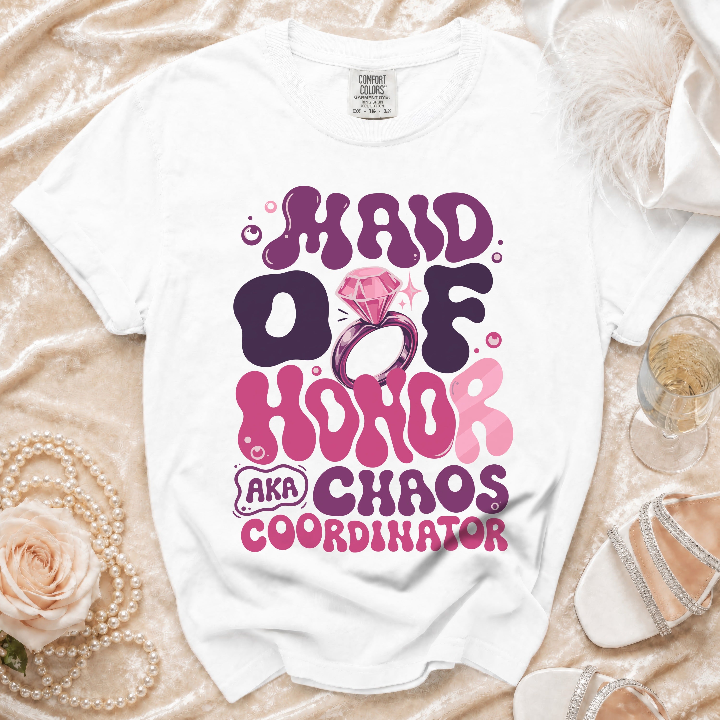 White t-shirt with "Maid of Honor AKA Chaos Coordinator" text and diamond ring graphic.