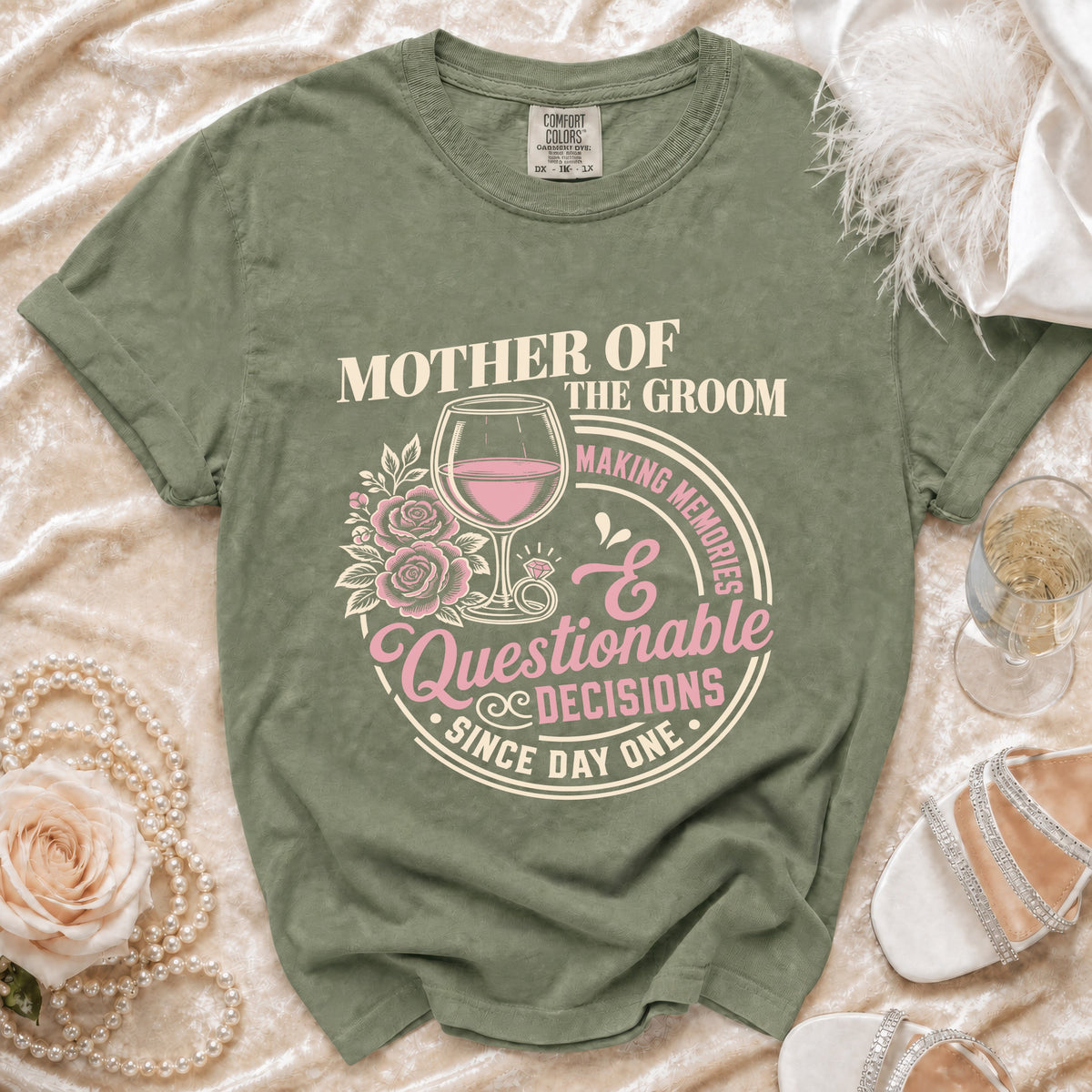 Green t-shirt with "Mother of the Groom Making Memories Questionable Decisions Since Day One" graphic.