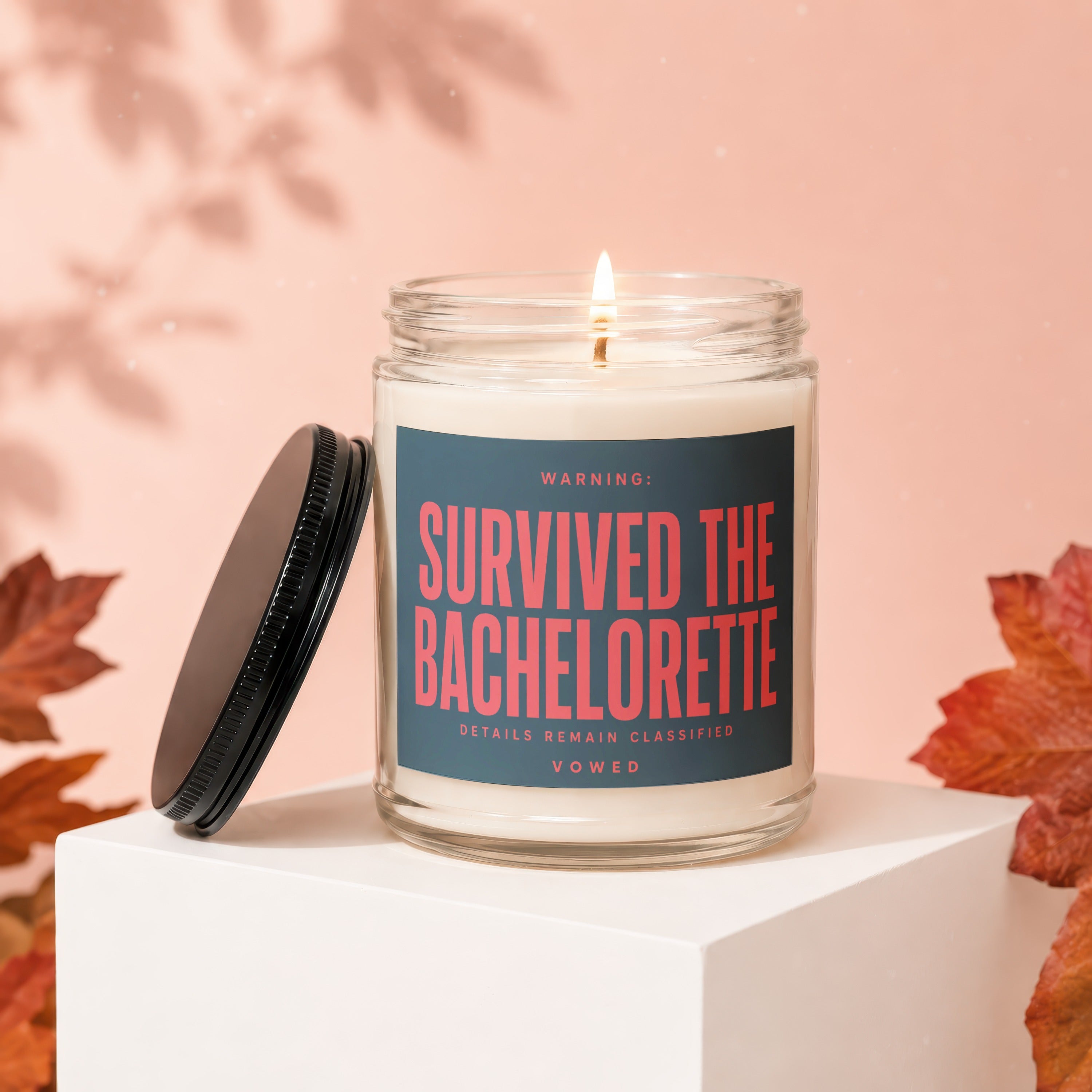 Lit candle with "Survived the Bachelorette" on label, lid beside it.
