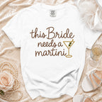 White t-shirt with "this Bride needs a martini" text and a martini glass graphic.