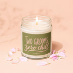 Candle with lit wick and green label reading "TWO GROOMS, Zero chill".