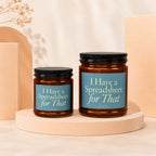 Two amber glass jar candles with black lids, labels read "I Have a Spreadsheet for That".