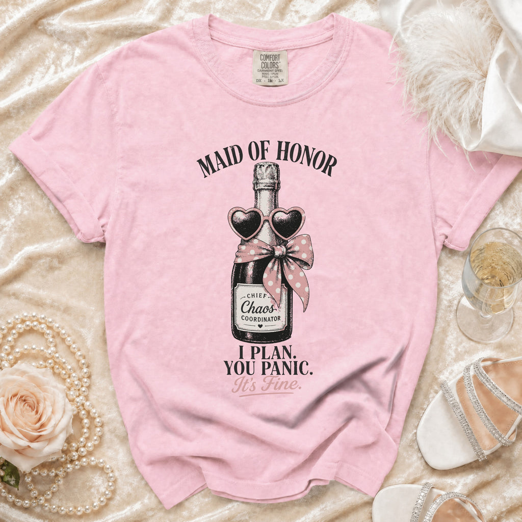 Pink t-shirt with champagne bottle graphic: "Maid of Honor," "Chief Chaos Coordinator," "I Plan. You Panic. It's Fine."