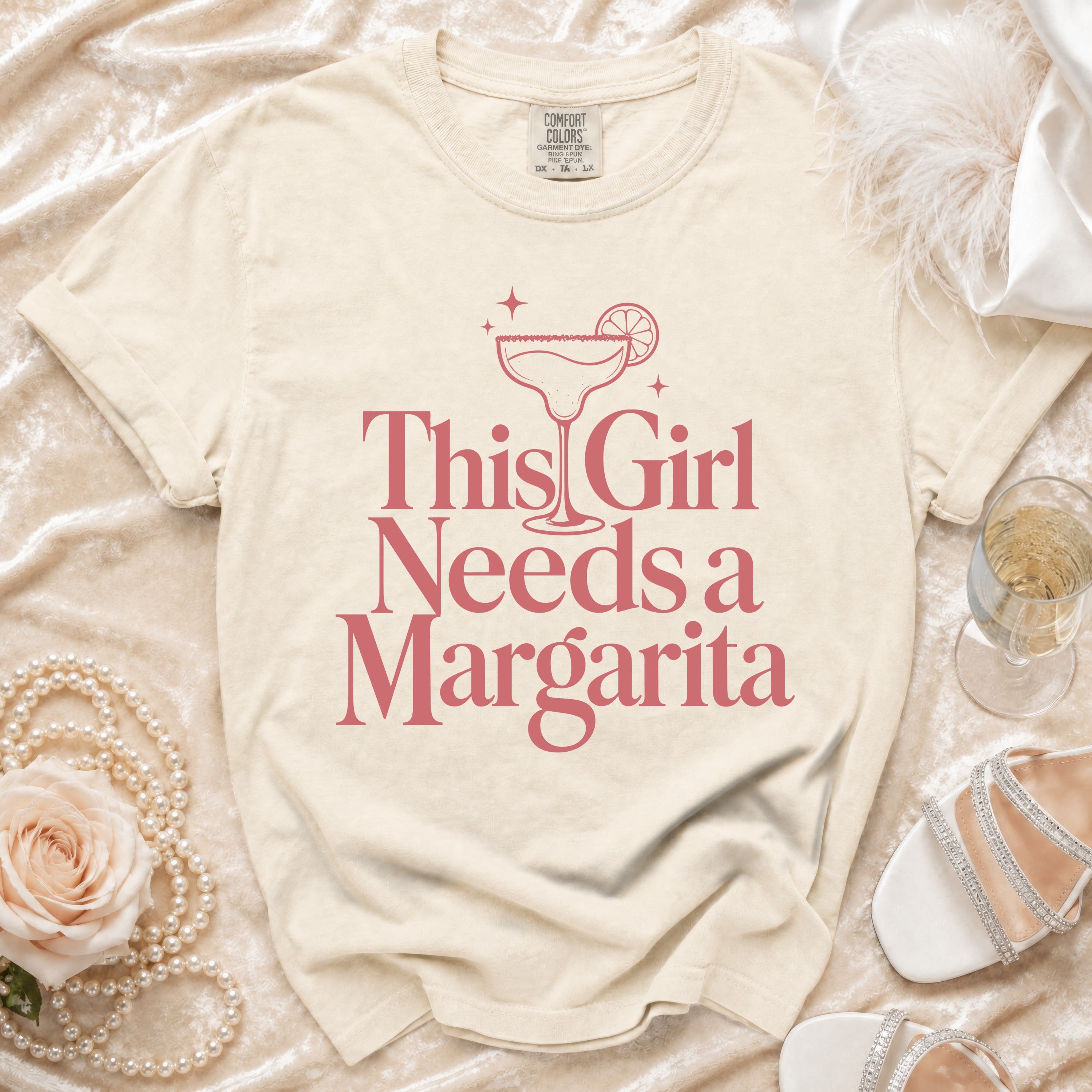 Cream t-shirt with "This Girl Needs a Margarita" graphic and margarita glass.