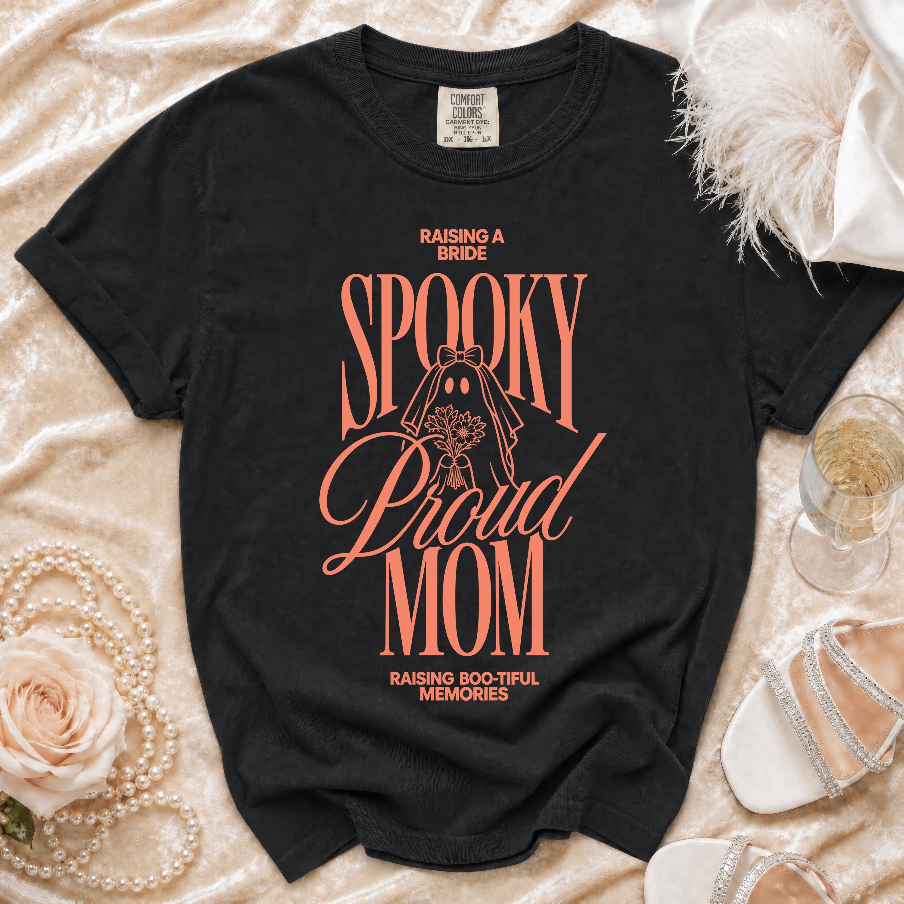 Black t-shirt with "Raising a Bride Spooky Proud Mom Raising Boo-tiful Memories" text.