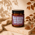 Brown candle with black lid and pink label reading "Two grooms, no notes, no chill."