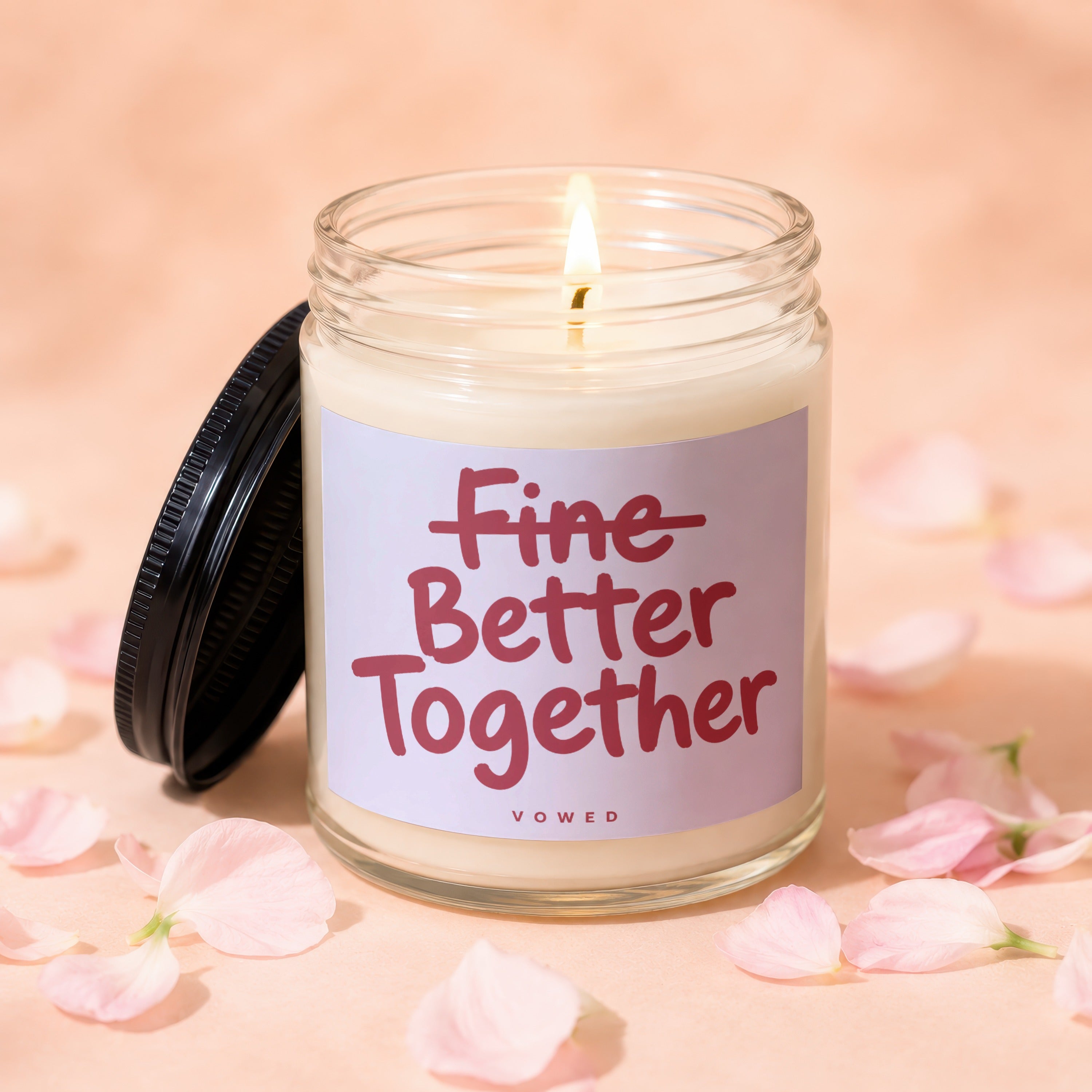Lit jar candle with "Fine Better Together" text and pink petals scattered around.