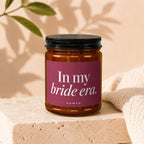 Amber jar candle with a magenta label saying "In my bride era. VOWED".