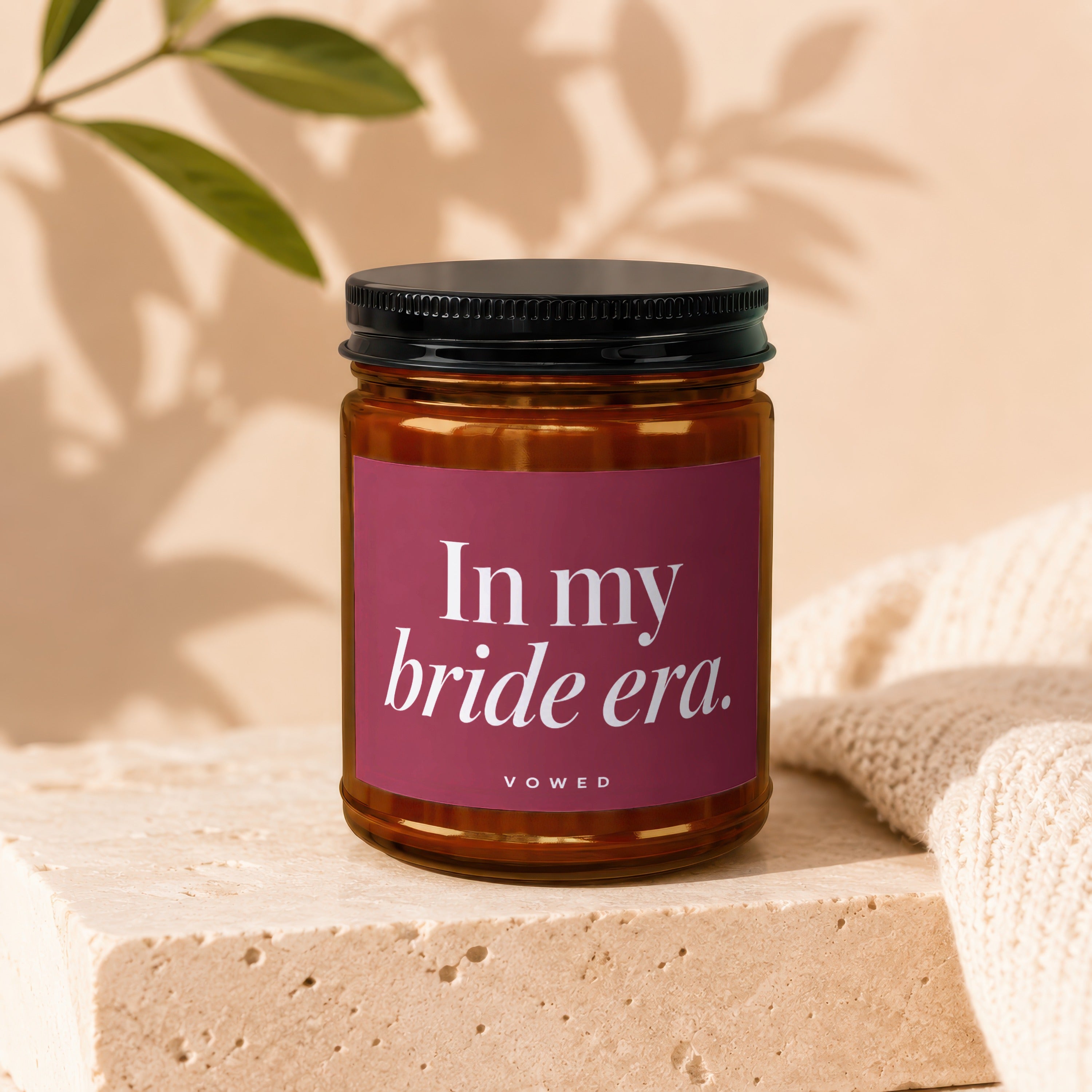 Amber jar candle with a magenta label saying "In my bride era. VOWED".