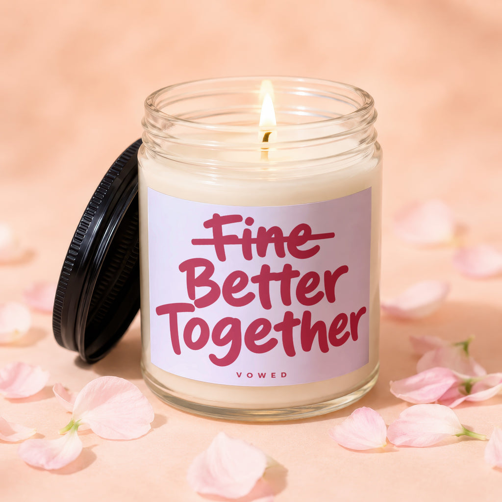 Candle with "Fine Better Together" text surrounded by pink petals.
