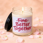 Candle with "Fine Better Together" text surrounded by pink petals.