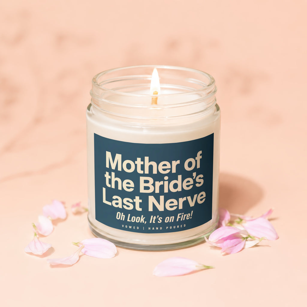 Candle with text "Mother of the Bride's Last Nerve" surrounded by pink petals.
