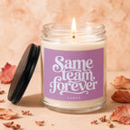 Scented candle with purple label reading "Same Team Forever Vowed".
