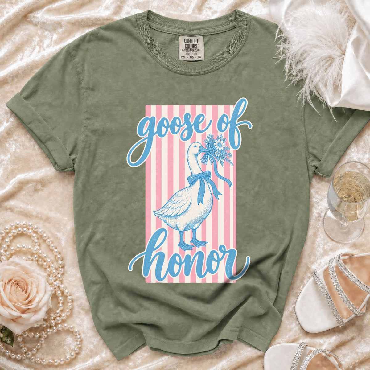 Olive green t-shirt with a goose of honor graphic featuring a goose holding flowers.