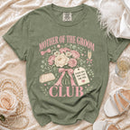 Olive green t-shirt with "Mother of the Groom Club" text and floral design.