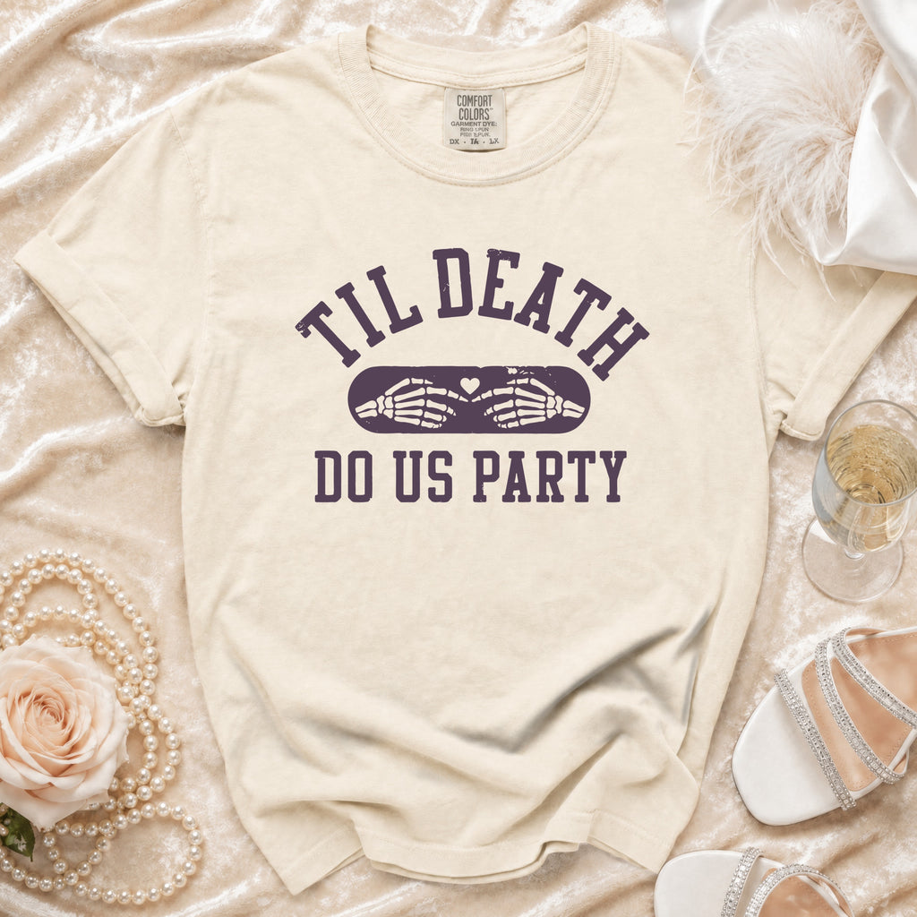 Cream t-shirt with "Til Death Do Us Party" text and skeleton hands.
