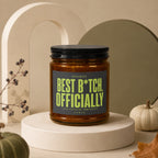 Amber jar candle with black lid reading "Best B*tch, Officially".
