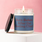 Lit candle in a glass jar with blue label that says "Burn Before After the Seating Chart."