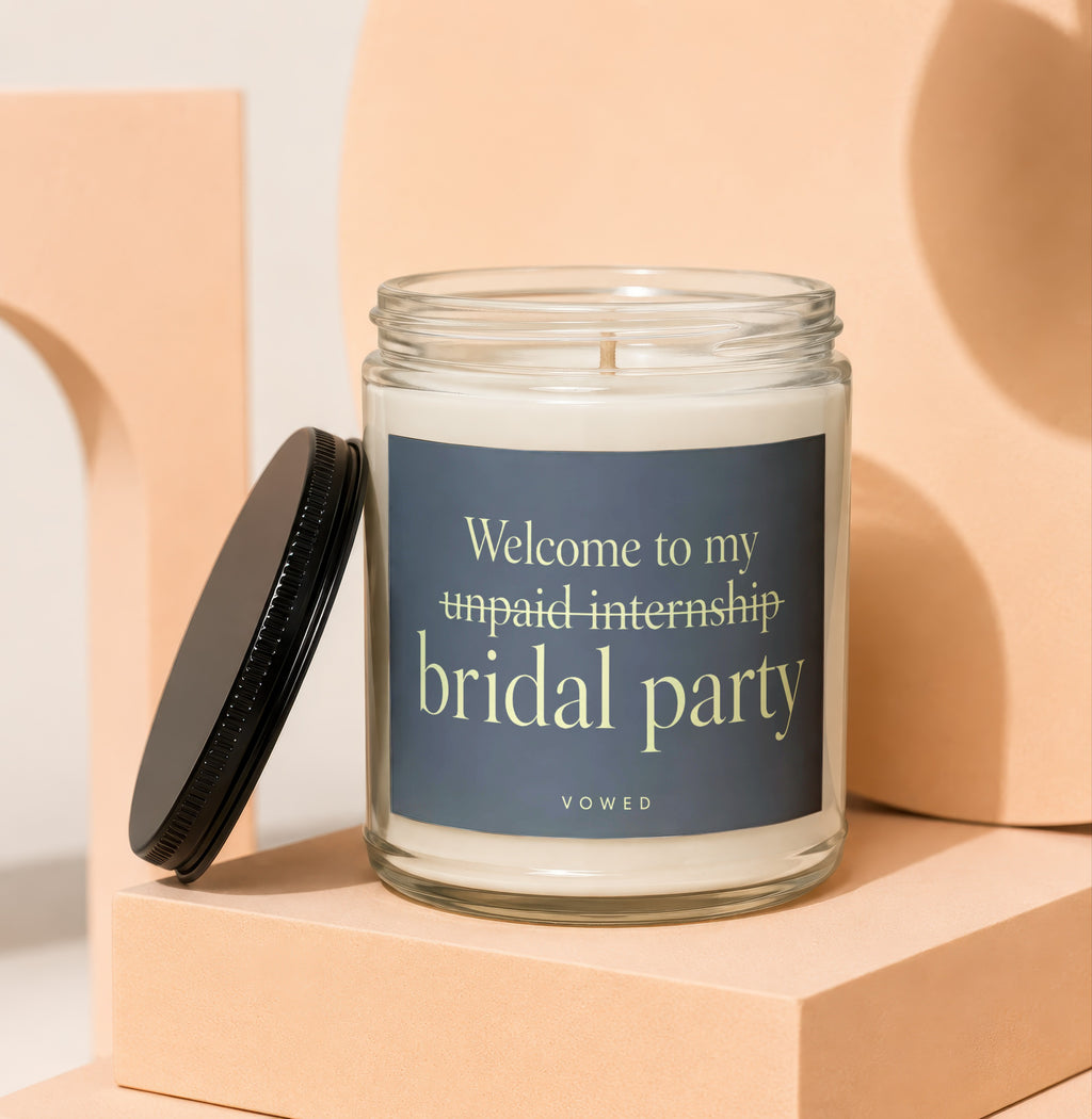 Candle with text "Welcome to my unpaid internship bridal party VOWED"