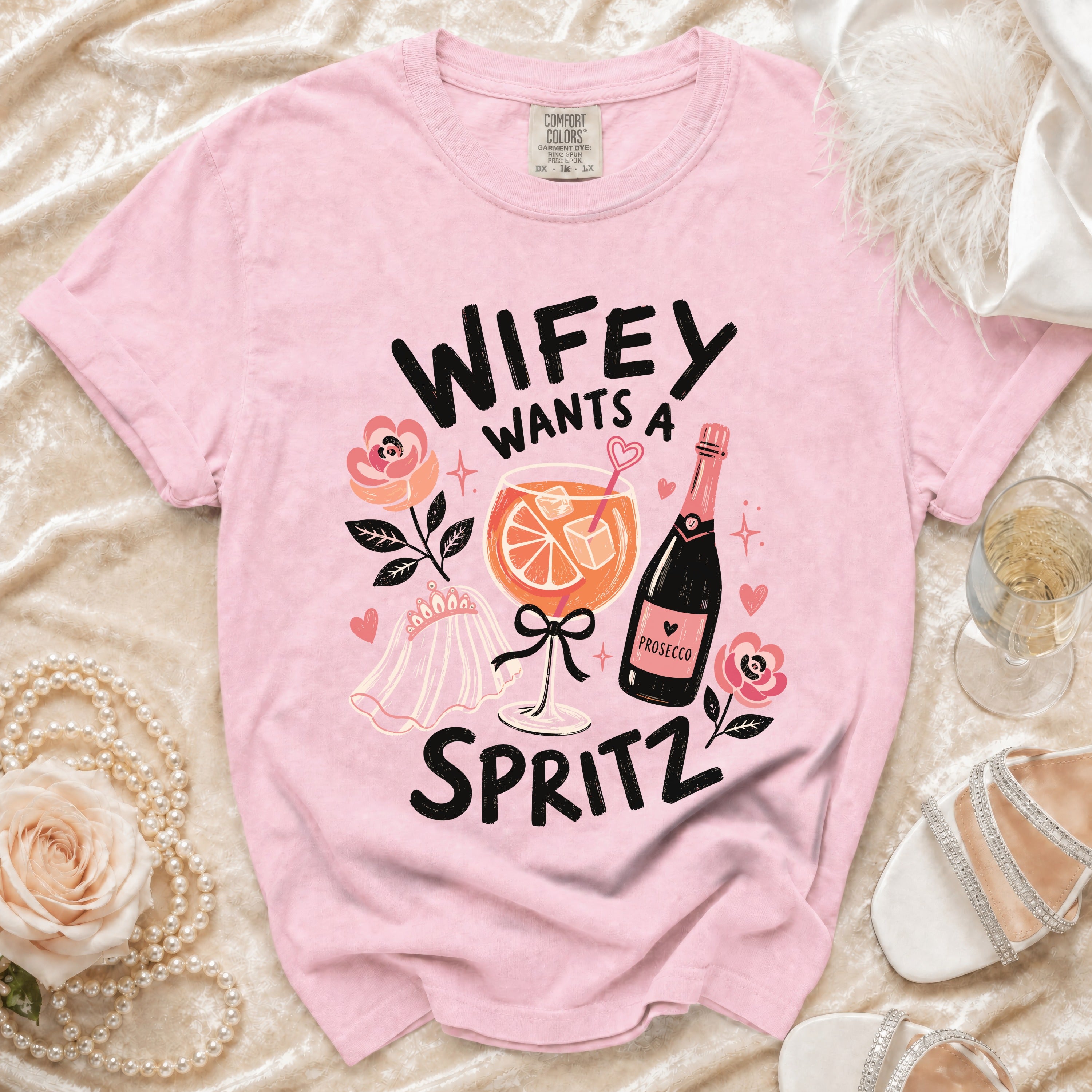 Pink t-shirt with "Wifey Wants A Spritz" graphic and prosecco bottle.
