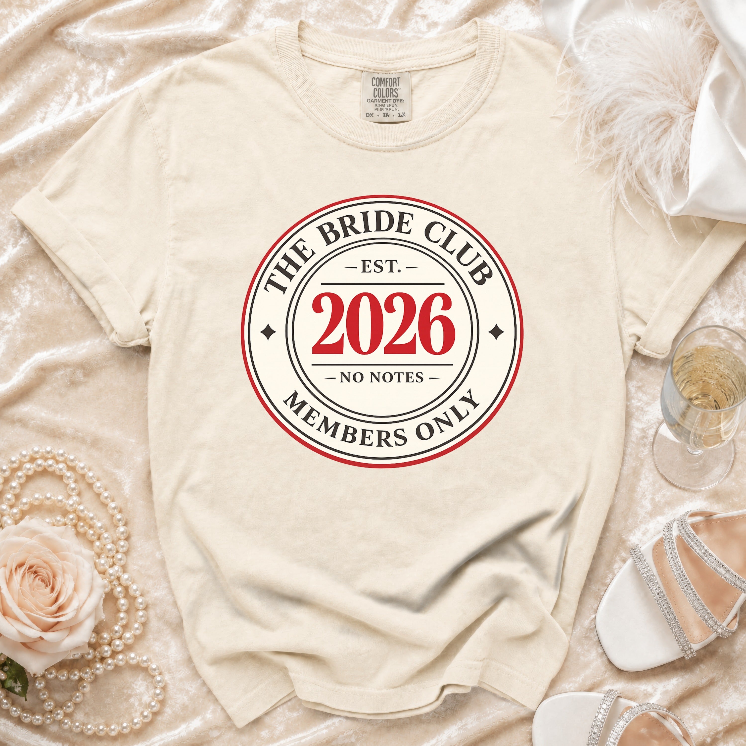 Cream t-shirt with "The Bride Club Est. 2026 Members Only" logo.