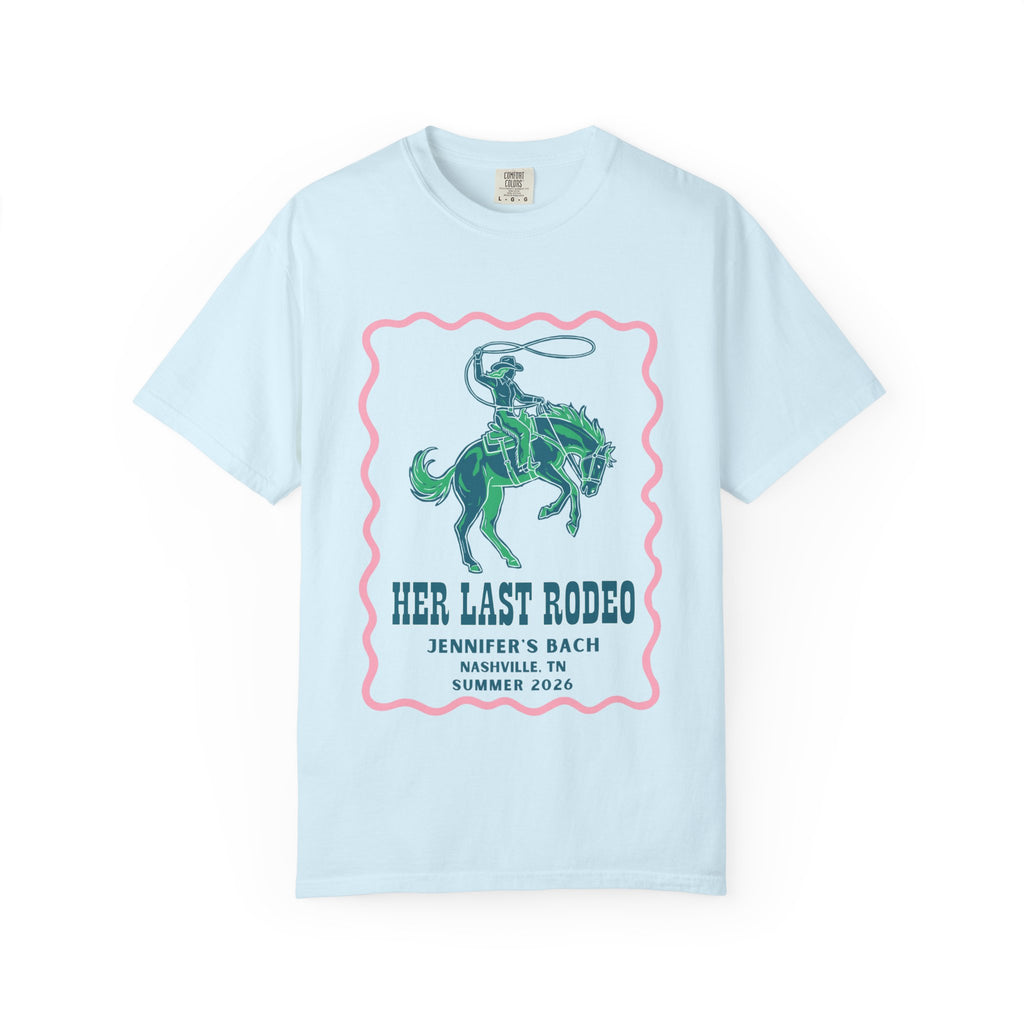 Light blue t-shirt with a pink border and a graphic of a rodeo rider.
