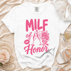 White t-shirt with pink text "MILF of Honor", lips, champagne glasses, and flowers.