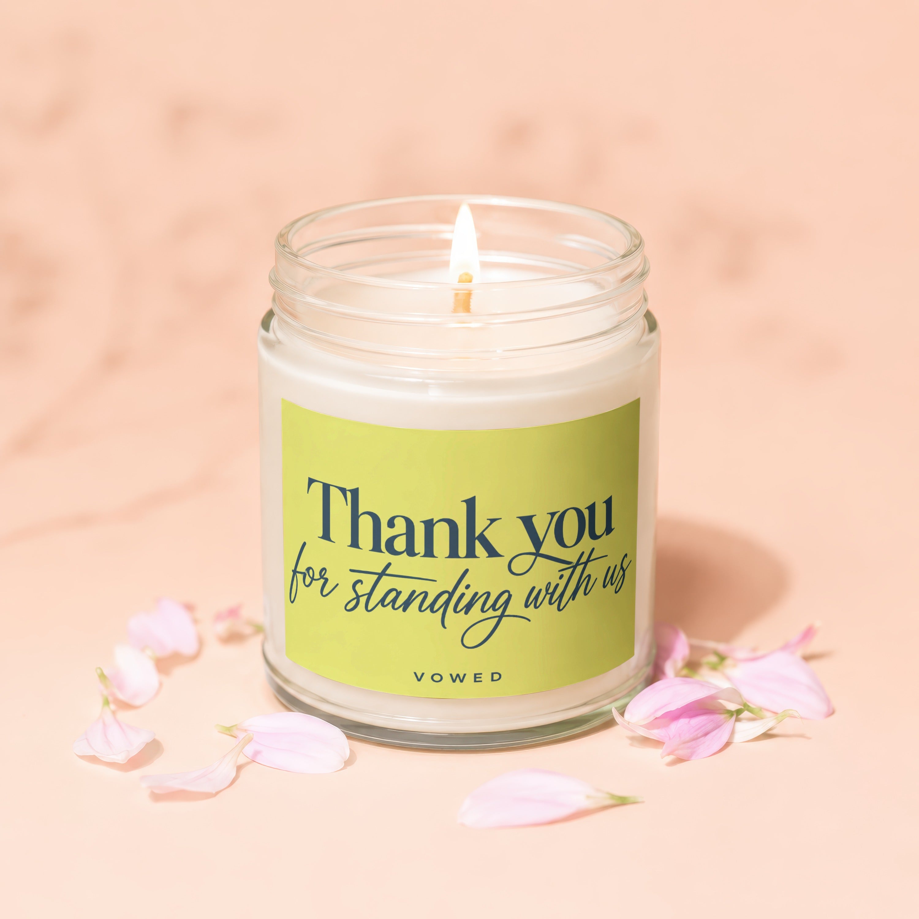 Candle with lit wick, "Thank you for standing with us" text, and scattered flower petals.