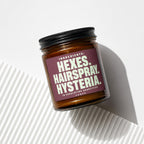 Amber jar labeled "Hextes. Hairspray. Hysteria. in Escalating Quantities."
