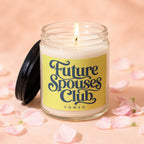 Candle with "Future Spouses Club" text on yellow label, surrounded by pink petals.