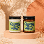 Two Vowed candles, one clear glass and one amber glass, with "Queerly Ever After" labels.