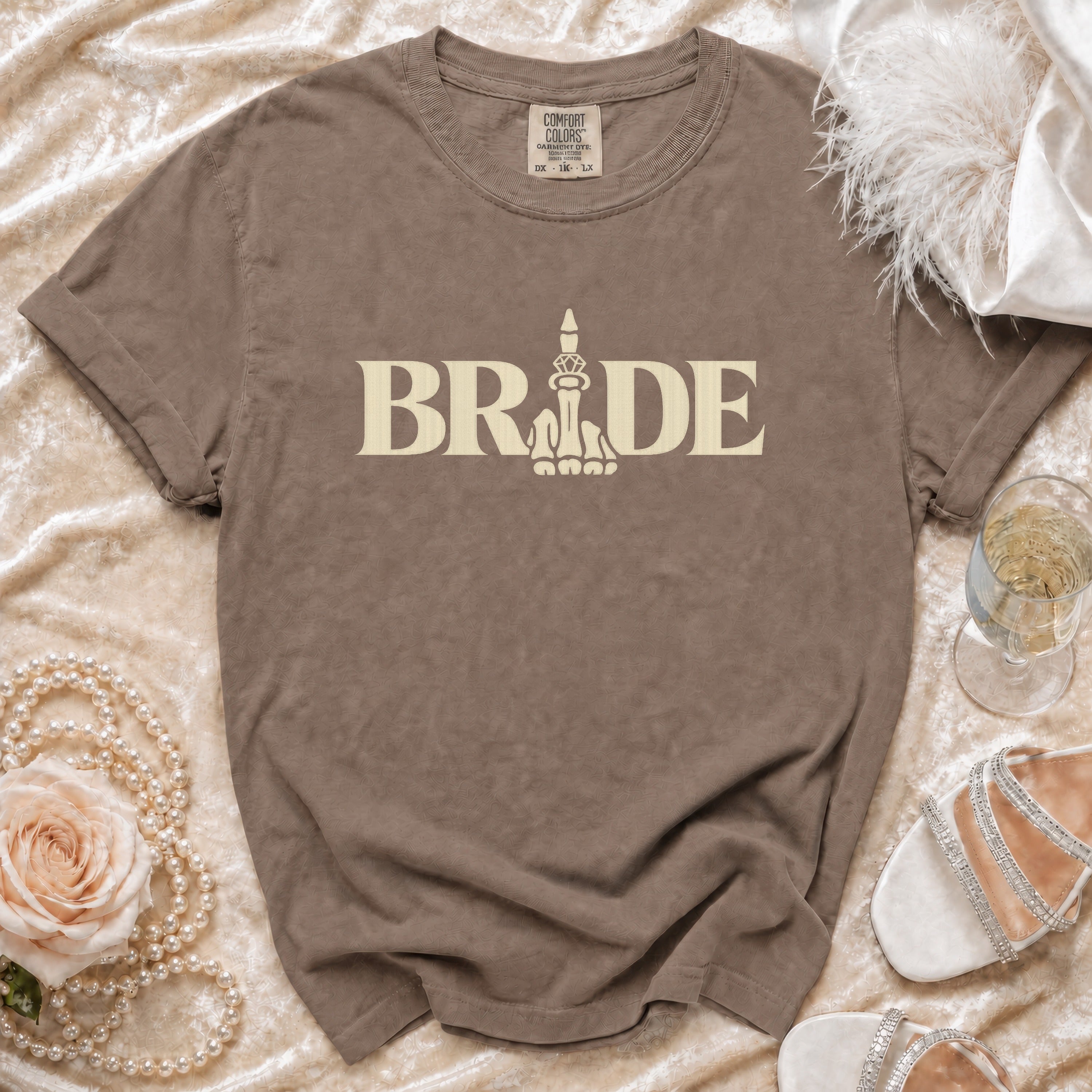 Brown t-shirt with "BRIDE" text and a stylized middle finger graphic.