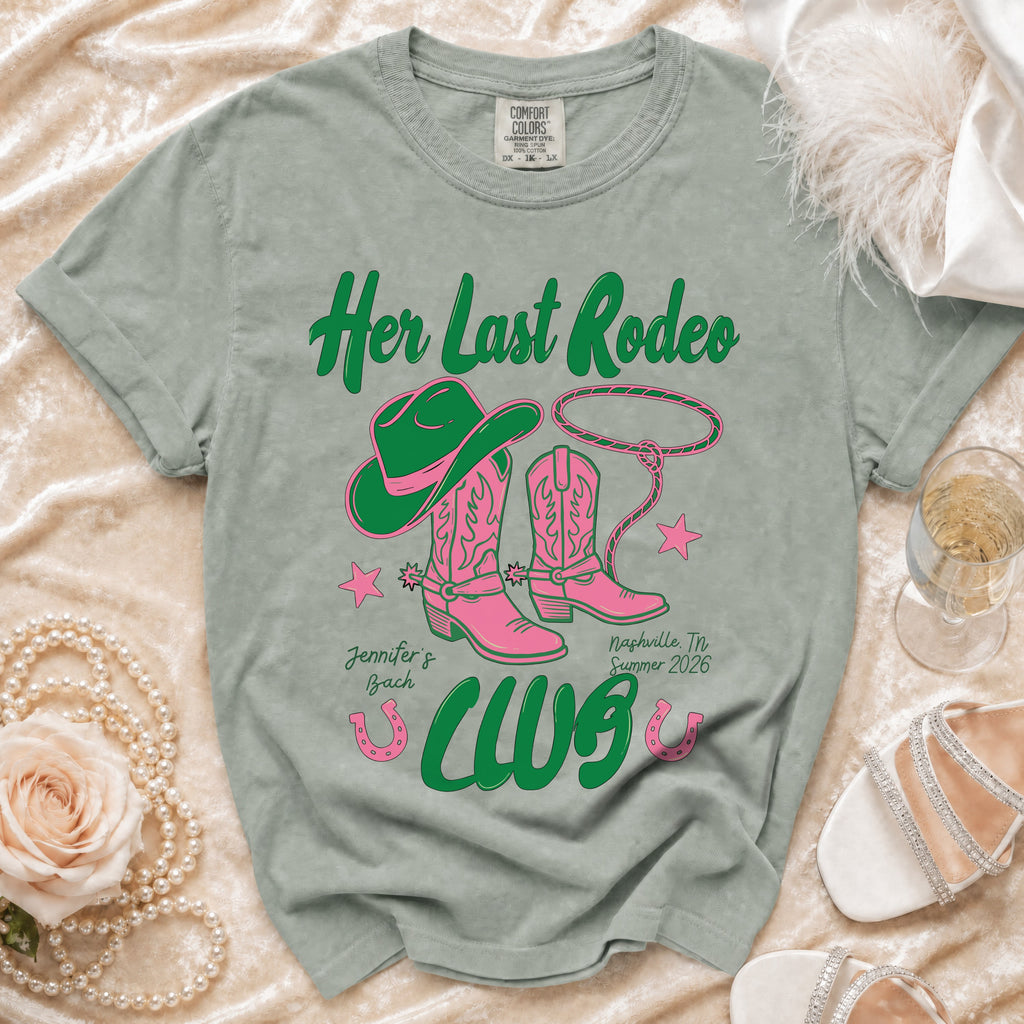 Green t-shirt with pink cowboy boots and hat reading "Her Last Rodeo".