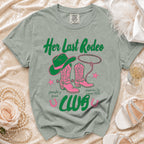 Green t-shirt with pink cowboy boots and hat reading "Her Last Rodeo".