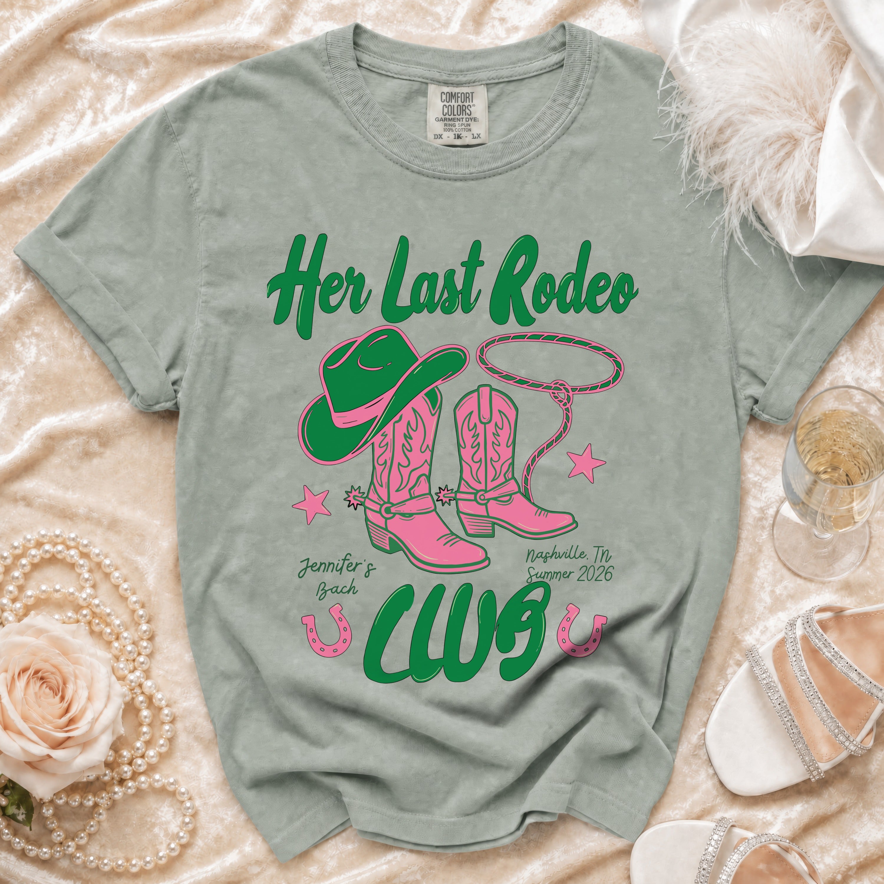 Green t-shirt with pink cowboy boots and hat reading "Her Last Rodeo".